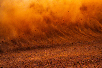 Dust kicked up by a race car on a dirt track 