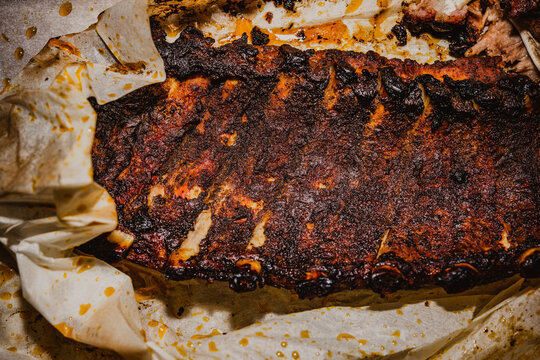 Smoked and cut pork ribs in parchment paper