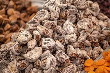 Dried persimmon fruits in the street market. sweet appetizing healthy dried persimmon