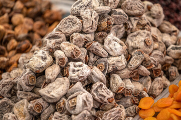 Fototapeta na wymiar Dried persimmon fruits in the street market. sweet appetizing healthy dried persimmon