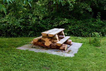 Benches and wooden table in a German forest. Handicraft table from tree trunk