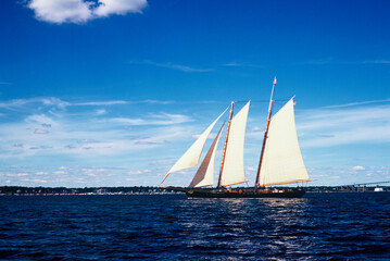 Sailboat on ocean with blue sky