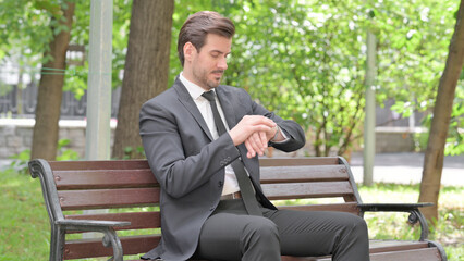 Waiting Young Businessman Sitting Outdoor