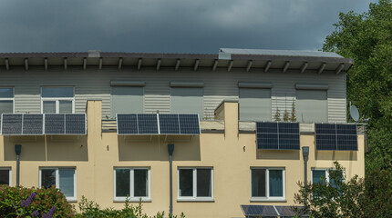 A terraced house with solar power plant on a balconies to generate green electrical energy for...