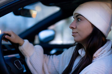 Serious young woman inside car. Waiting concept.