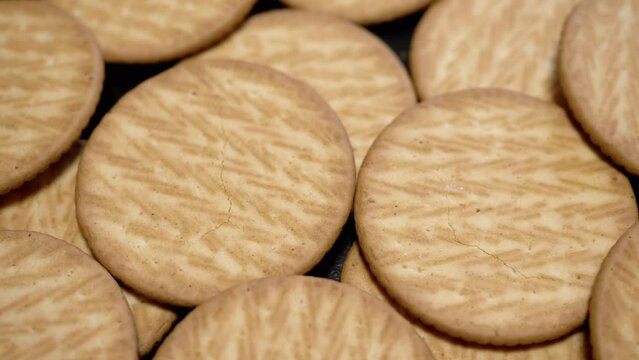 Close up, Round Crispy Shortbread Cookies Rotate on a Turntable, Background. Tasty bunch of crackers. Top view. Healthy food concept. Sweet pastries. Food background. Sale. Texture. Slow motion.