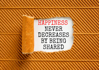 Happiness symbol. Concept words Happiness never decreases by being shared on beautiful white paper. Beautiful brown background. Motivational Happiness concept. Copy space.