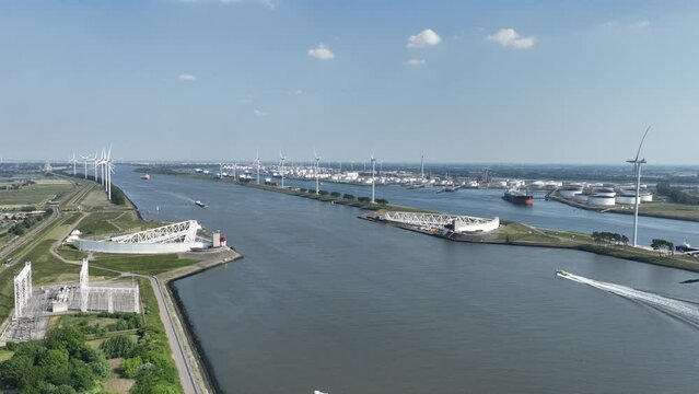 Aerial drone video of The Maeslantkering storm surge barrier coastal flood defence system that was commissioned in 1997 on the border of Het Scheur and the Nieuwe Waterweg near Hoek van Holland