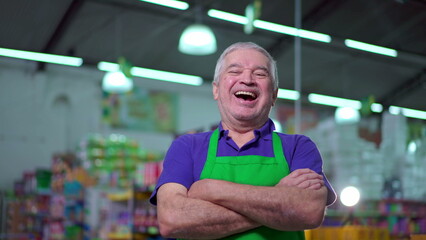 Joyful Supermarket Manager with Arms Crossed, smiling Expression of Older Small Business Owner Inside Store