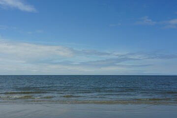 Fototapeta premium North Sea and cloudy sky on the beach of Sankt Peter-Ording, Schleswig-Holstein, North Germany
