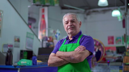 Joyful Supermarket Manager with Arms Crossed, smiling Expression of Older Small Business Owner Inside Store