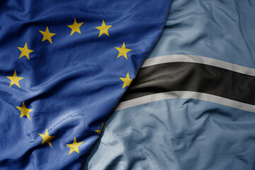 big waving realistic national colorful flag of european union and national flag of botswana .