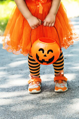 background with child dressed in festive costume for Halloween trick or treating. kid in orange...