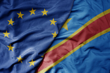 big waving realistic national colorful flag of european union and national flag of democratic republic of the congo .