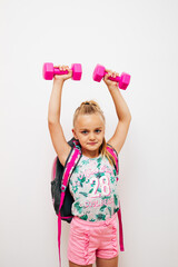 A little girl lifts weights