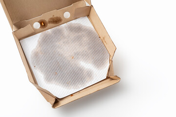 Empty pizza box with grease stains isolated on white. Top view. Copy space.