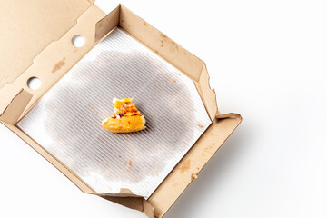Leftover corn pizza in an open cardboard pizza box isolated on white background. Top view
