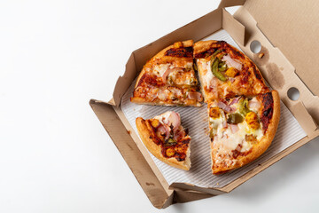 Two different leftover pizza in open cardboard box isolated on white background. top view