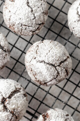 Chocolate chip cookies with cracks on metallic rack on light gray background, xmas food