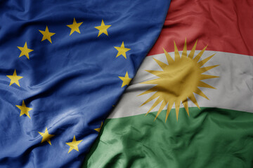 big waving realistic national colorful flag of european union and national flag of kurdistan .