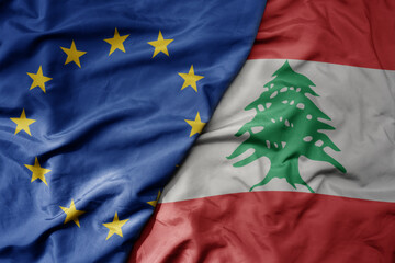 big waving realistic national colorful flag of european union and national flag of lebanon .