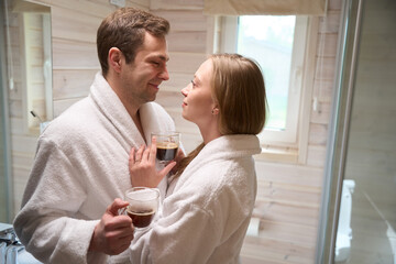 Young couple in the bathroom looking at each other