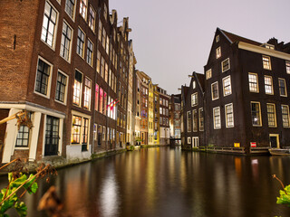 Fototapeta na wymiar Amsterdam architecture and canal views in city lights during Christmas. Netherlands