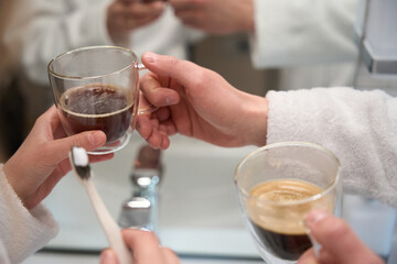 Close-up of male and female hand holding cup of coffee