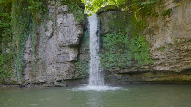 Waterfall in the mountains. Water falls from the rock. Waterfall Giessen, Canton Baselland, Switzerland.