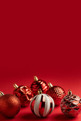 Vertical Christmas poster with red balls on a red background