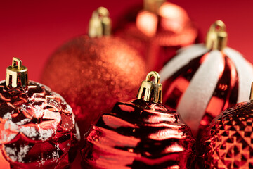 closeup of red christmas balls with different designs