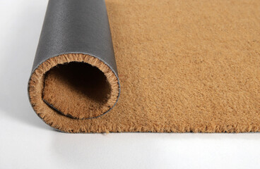Natural brown coconut fiber doormat. Plain natural dry carpet and dirt outside your entrance, Detail, closeup of fiber and base on white background.