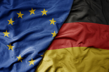 big waving realistic national colorful flag of european union and national flag of germany .