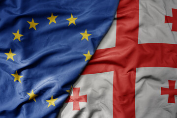 big waving realistic national colorful flag of european union and national flag of georgia .