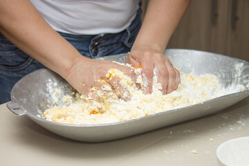Woman hands cooking traditional colombian round fritters, freshly made at home, snack and typical Colombian breakfast.