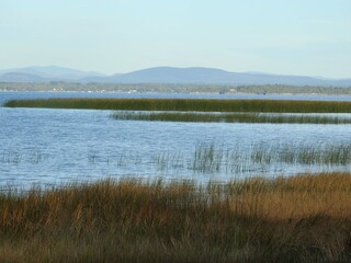 A picturesque view of Lake Champlain from the shores of the Ausable Marsh Wildlife Management Area, with the Adirondack Mountains in the background, Clinton County, Upstate New York.  