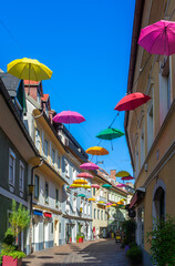 Villach, Austria - July 12, 2023: Colorful umbrellas hanging over the street of Villach, Austria