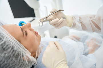 Young female patient in a dental chair on tooth extraction