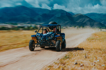 Father and son driving fast buggy on mountain road, blurred motion © chaossart