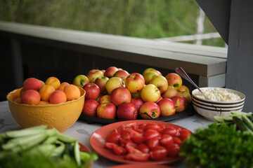 Fresh fruits, vegetables and herbs on plates, outdoors