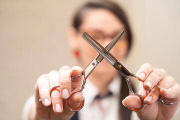 Female holds hairdressing scissors in her hands