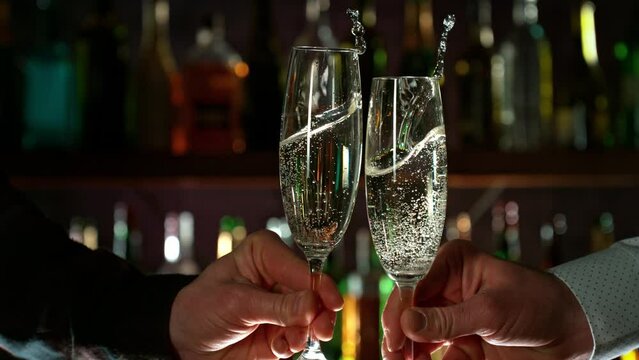 Super Slow Motion Shot of Champagne Cheering Before Bar at 1000fps.