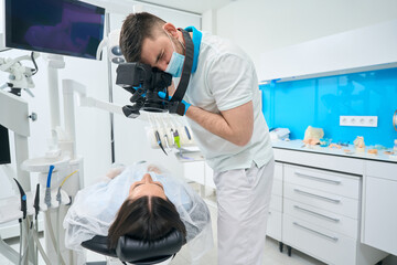 Brunette woman lies in a dental chair