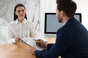 Human resources manager conducting job interview with applicant in office