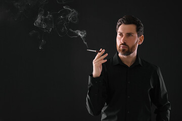 Man using cigarette holder for smoking on black background, space for text
