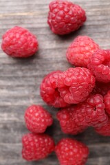 Tasty ripe raspberries on wooden table, top view