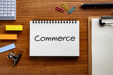 There is notebook with the word Commerce. It is as an eye-catching image.