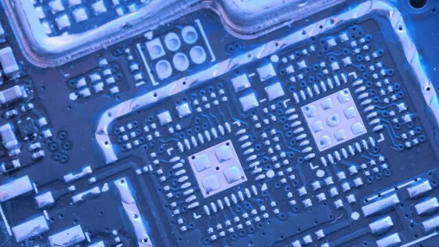 Microchip and microprocessors, top view. Computer PC chip blue light close up. Computer motherboard components.