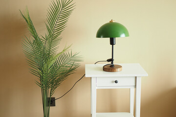a table lamp in home against orange color wall