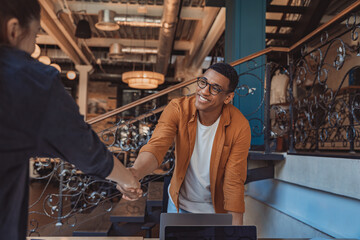 CLose up of two professional business people shaking hands at office meeting. Partnership concept